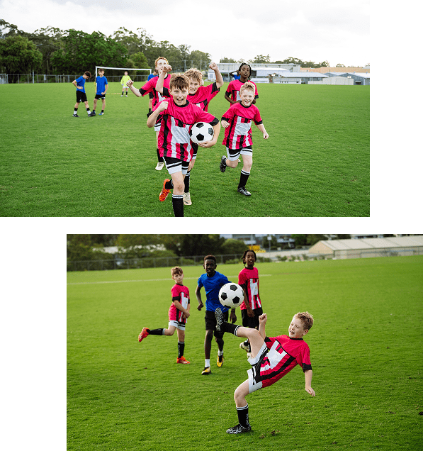 Kids playing soccer on a grassy field.